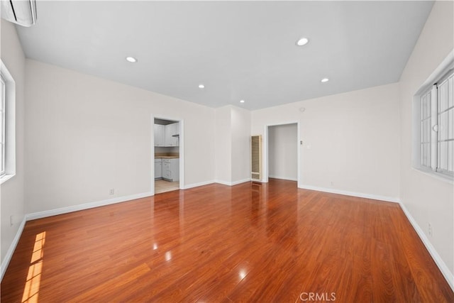 2047 Delford Ave, Duarte, CA 91010 - unfurnished room with wood finished floors, recessed lighting, healthy amount of natural light, and a wall unit AC