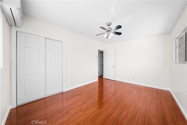 2047 Delford Ave, Duarte, CA 91010 - unfurnished bedroom with a wall mounted AC, wood finished floors, a closet, and ceiling fan