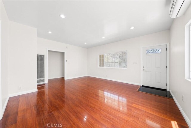 2047 Delford Ave, Duarte, CA 91010 - unfurnished living room featuring an AC wall unit, a heating unit, wood finished floors, and recessed lighting
