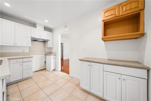 2047 Delford Ave, Duarte, CA 91010 - kitchen featuring under cabinet range hood, recessed lighting, light countertops, light tile patterned floors, and white cabinets