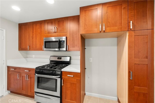 22271 Caminito Danubo, Laguna Hills, CA 92653 - kitchen featuring appliances with stainless steel finishes, brown cabinets, light countertops, and recessed lighting