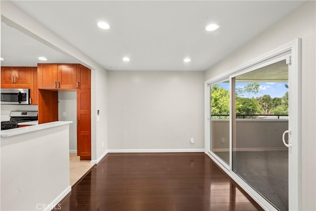 22271 Caminito Danubo, Laguna Hills, CA 92653 - kitchen with stainless steel appliances, recessed lighting, wood finished floors, light countertops, and brown cabinetry