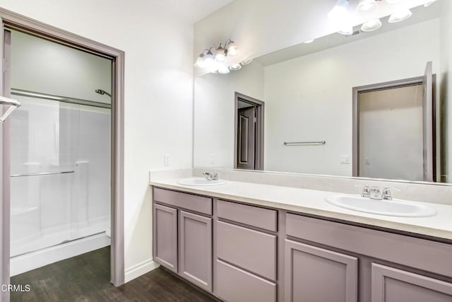 4069 Bristlecone Pine Ln, San Bernardino, CA 92407 - bathroom with double vanity, wood finished floors, and a shower