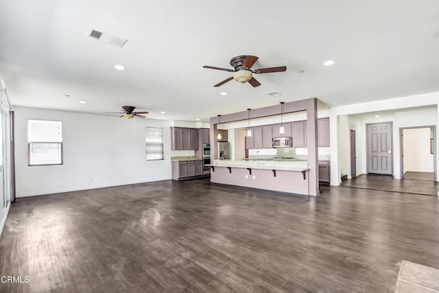 4069 Bristlecone Pine Ln, San Bernardino, CA 92407 - unfurnished living room featuring a ceiling fan, dark wood-type flooring, and recessed lighting