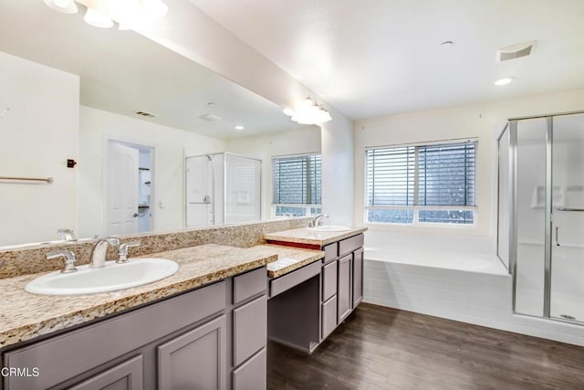 4069 Bristlecone Pine Ln, San Bernardino, CA 92407 - bathroom featuring double vanity, a shower stall, a bath, and wood finished floors