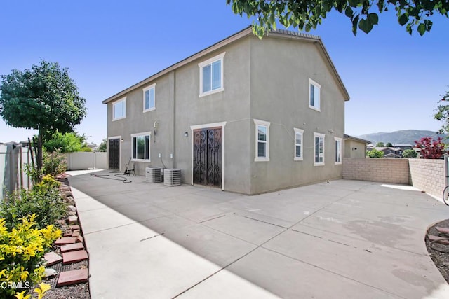 4069 Bristlecone Pine Ln, San Bernardino, CA 92407 - back of property featuring stucco siding, a patio, and a fenced backyard