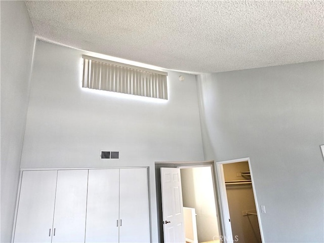 6801 Mammoth Ave Unit 6, Van Nuys, CA 91405 - unfurnished bedroom with a textured ceiling, a closet, and a towering ceiling