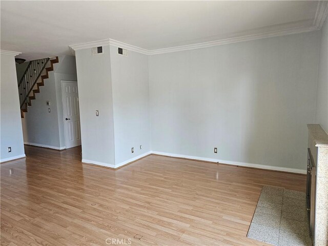 6801 Mammoth Ave Unit 6, Van Nuys, CA 91405 - unfurnished living room with stairs, light wood-style floors, and ornamental molding