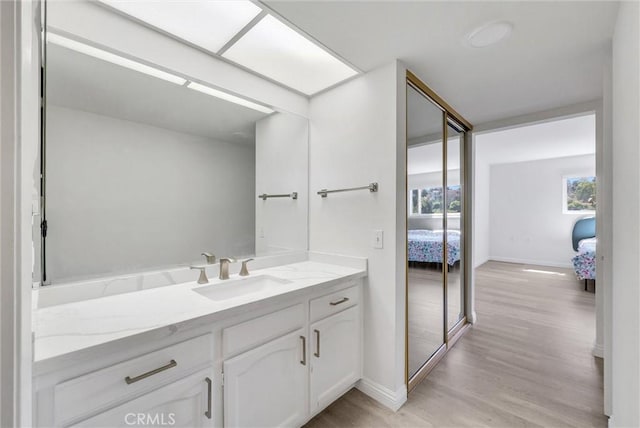 5510 Paseo Del Lago W Unit 2D, Laguna Woods, CA 92637 - ensuite bathroom featuring vanity and wood finished floors