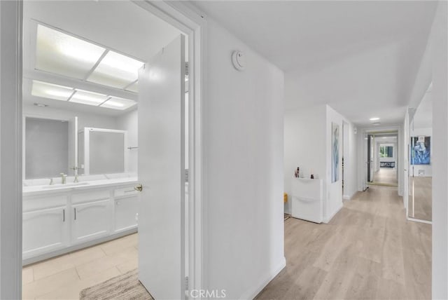 5510 Paseo Del Lago W Unit 2D, Laguna Woods, CA 92637 - corridor featuring a sink and baseboards