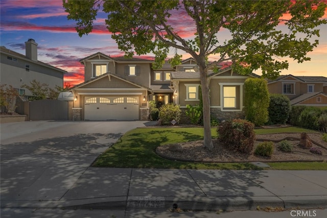 40433 Wgasa Pl, Temecula, CA 92591 - view of front of house featuring stone siding, concrete driveway, an attached garage, and stucco siding