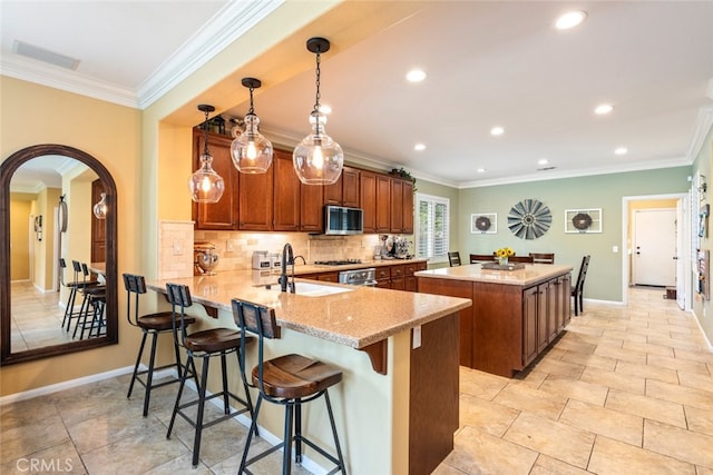 40433 Wgasa Pl, Temecula, CA 92591 - kitchen with stainless steel microwave, a center island, ornamental molding, recessed lighting, and backsplash