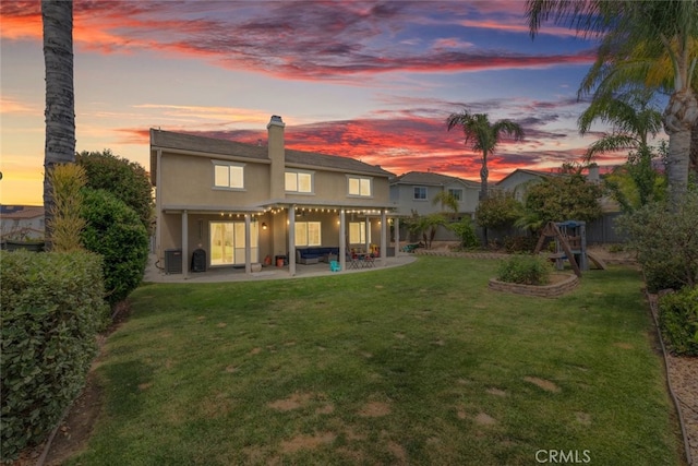 40433 Wgasa Pl, Temecula, CA 92591 - back of property at dusk featuring a patio area, stucco siding, a chimney, and a fenced backyard