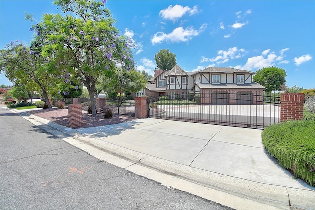 6735 Calais Ct, Riverside, CA 92506 - tudor-style house with a gate, stucco siding, and driveway
