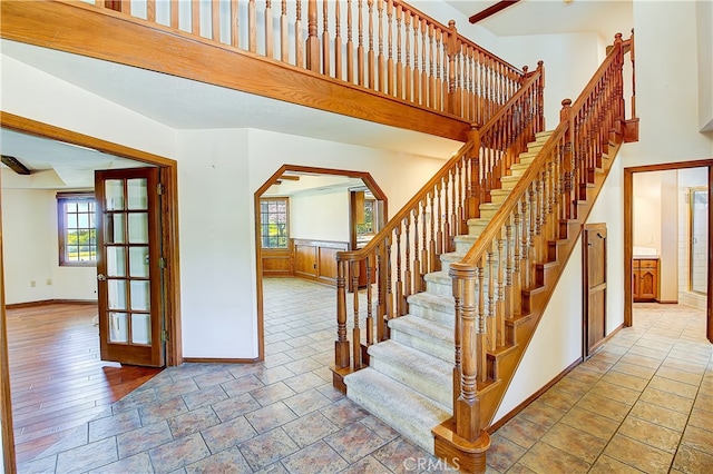 6735 Calais Ct, Riverside, CA 92506 - stairs featuring plenty of natural light, arched walkways, and stone finish floors