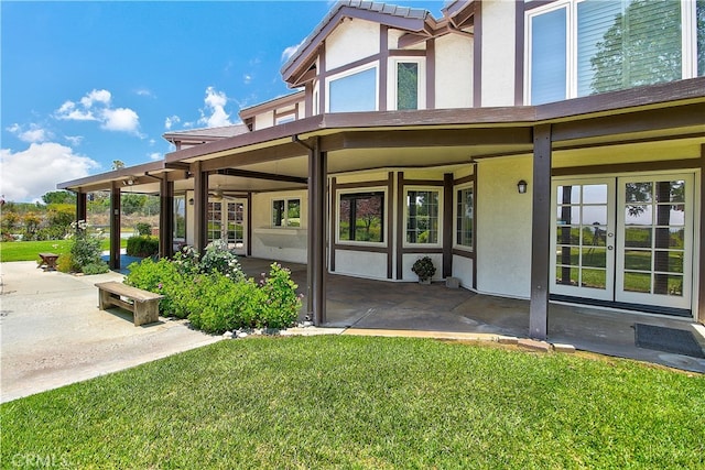 6735 Calais Ct, Riverside, CA 92506 - back of property with french doors, stucco siding, and a patio