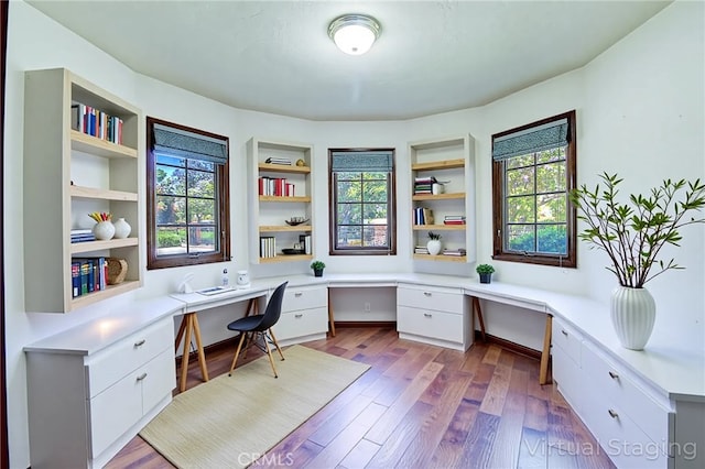 6735 Calais Ct, Riverside, CA 92506 - office area featuring built in desk, healthy amount of natural light, and wood finished floors