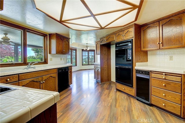 6735 Calais Ct, Riverside, CA 92506 - kitchen featuring black appliances, tile countertops, brown cabinets, and a ceiling fan