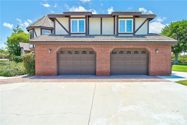 6735 Calais Ct, Riverside, CA 92506 - english style home featuring stucco siding, an attached garage, brick siding, and driveway