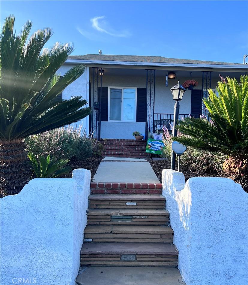 1474 W 1st St, San Pedro, CA 90732 - view of front of home featuring stucco siding and covered porch