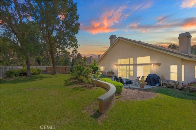 32244 Corte Coronado, Temecula, CA 92592 - back of house at dusk featuring a chimney, a patio, and stucco siding