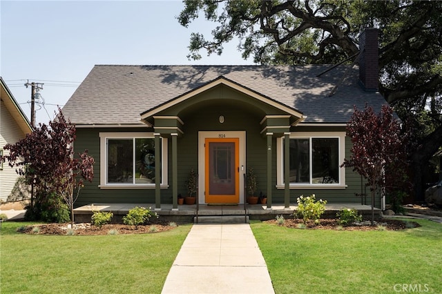 814 E Foothill Blvd, Monrovia, CA 91016 - view of front facade with covered porch, a shingled roof, a chimney, and a front yard