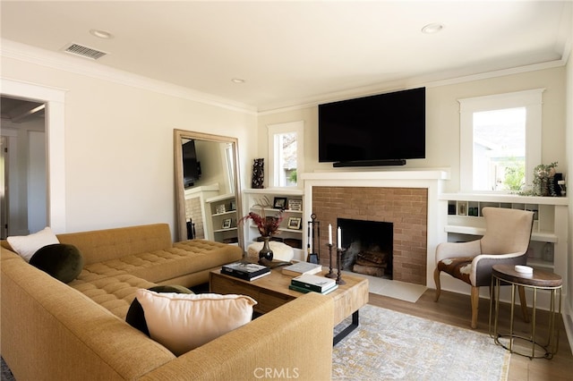 814 E Foothill Blvd, Monrovia, CA 91016 - living area featuring healthy amount of natural light, crown molding, wood finished floors, a brick fireplace, and recessed lighting