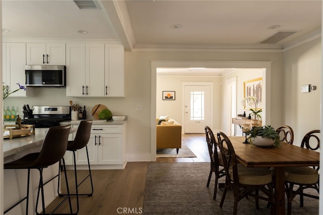 814 E Foothill Blvd, Monrovia, CA 91016 - dining area featuring dark wood finished floors and ornamental molding