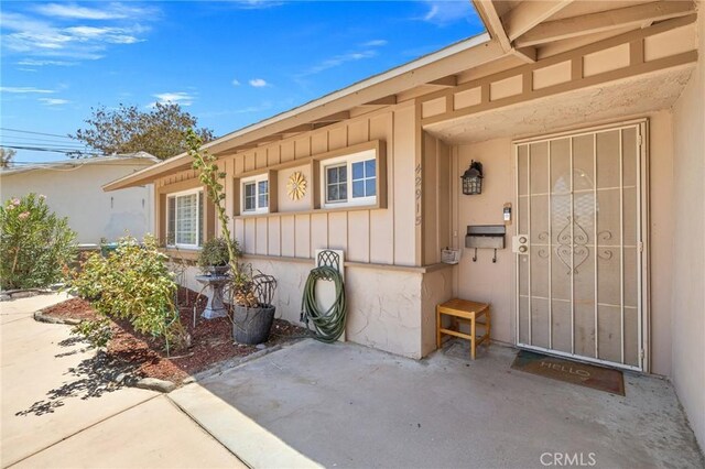 42915 Wisconsin Ave, Palm Desert, CA 92211 - doorway to property with board and batten siding and a patio