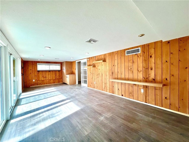 42915 Wisconsin Ave, Palm Desert, CA 92211 - unfurnished room featuring wood walls, wood finished floors, and a textured ceiling