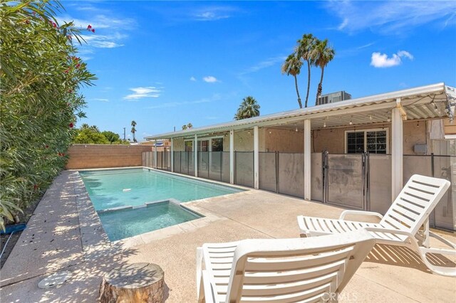 42915 Wisconsin Ave, Palm Desert, CA 92211 - view of swimming pool featuring a patio, a fenced backyard, and a pool with connected hot tub