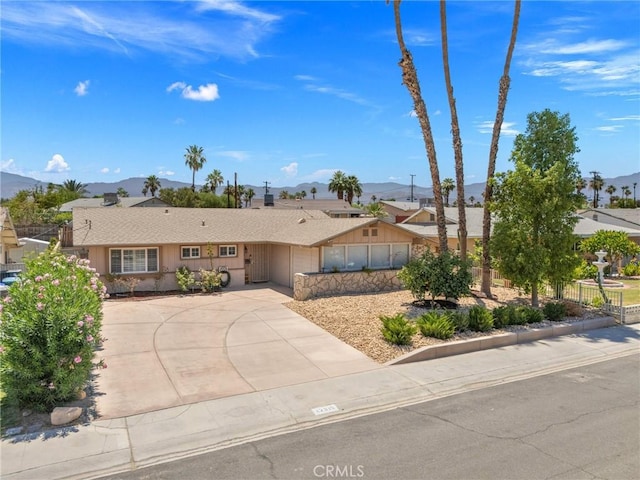 42915 Wisconsin Ave, Palm Desert, CA 92211 - ranch-style home with a mountain view, a garage, and concrete driveway