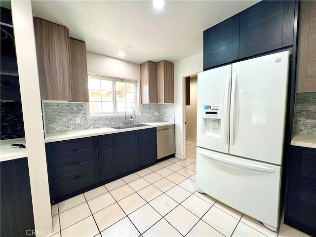 42915 Wisconsin Ave, Palm Desert, CA 92211 - kitchen featuring white fridge with ice dispenser, dishwasher, decorative backsplash, and light countertops