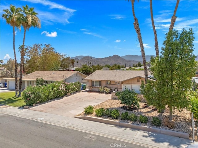 42915 Wisconsin Ave, Palm Desert, CA 92211 - single story home featuring a mountain view, driveway, and an attached garage