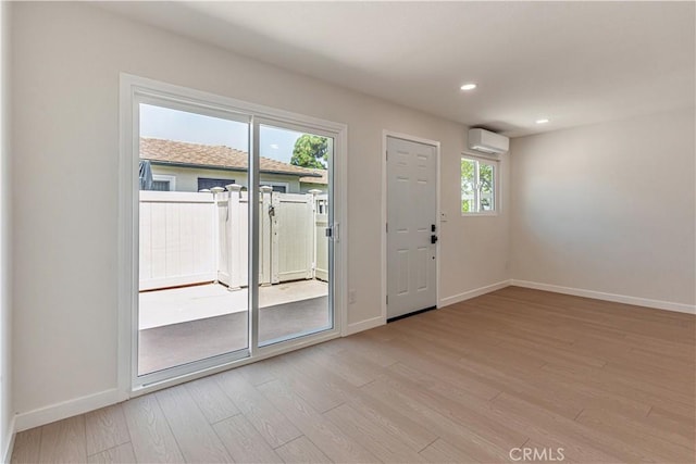 1640 235th St Unit D, Harbor City, CA 90710 - doorway with a wall mounted AC, healthy amount of natural light, light wood-type flooring, and recessed lighting