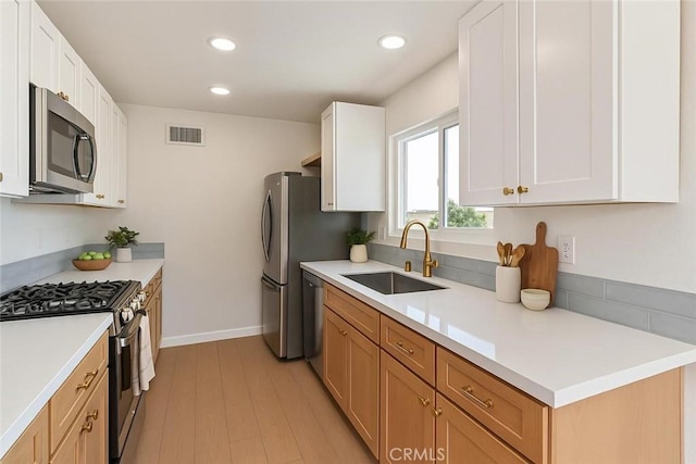 1640 235th St Unit D, Harbor City, CA 90710 - kitchen with stainless steel appliances, light countertops, light wood-style floors, recessed lighting, and white cabinets