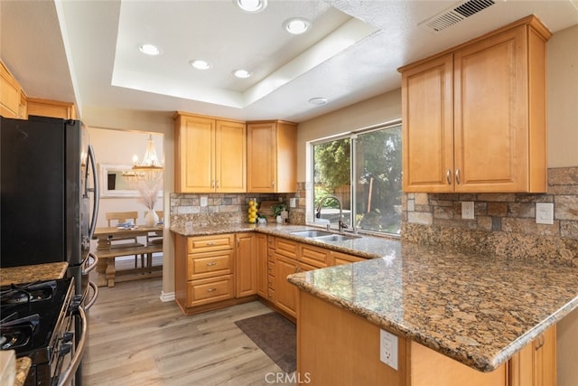 13100 Red Corral Dr, Corona, CA 92883 - kitchen with light wood-type flooring, range with gas cooktop, a tray ceiling, recessed lighting, and backsplash