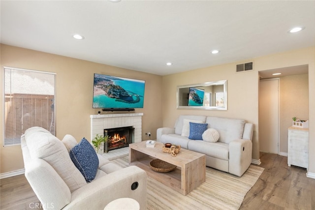 13100 Red Corral Dr, Corona, CA 92883 - living room featuring light wood-style floors, a brick fireplace, and recessed lighting