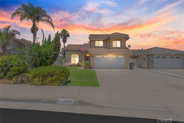 13100 Red Corral Dr, Corona, CA 92883 - mediterranean / spanish-style house featuring stucco siding, driveway, a tile roof, and a front yard