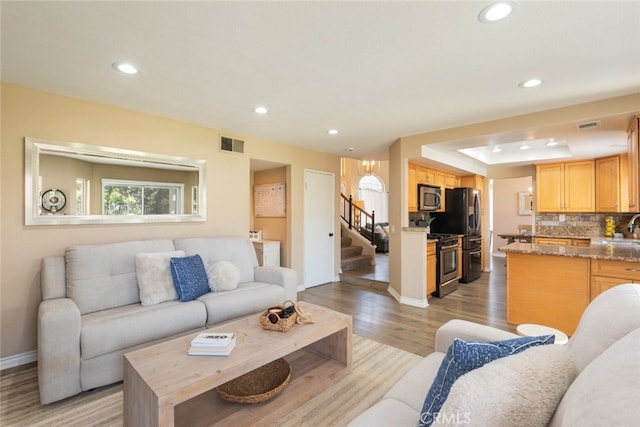 13100 Red Corral Dr, Corona, CA 92883 - living area with recessed lighting, light wood-style floors, and stairs