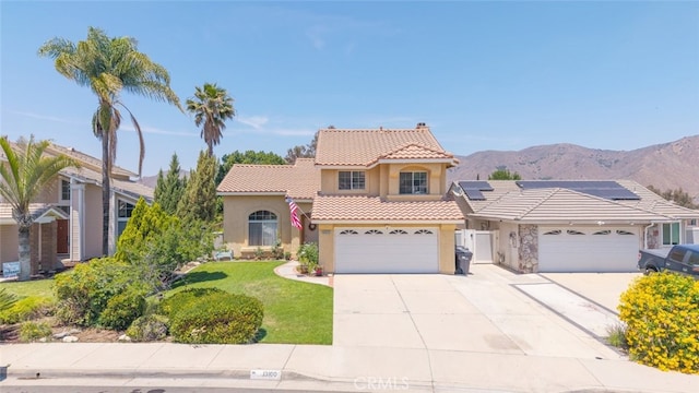 13100 Red Corral Dr, Corona, CA 92883 - mediterranean / spanish house with stucco siding, a tiled roof, driveway, a mountain view, and a front yard
