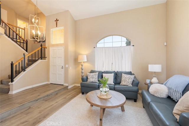 13100 Red Corral Dr, Corona, CA 92883 - living room with a chandelier, wood finished floors, stairs, and a towering ceiling