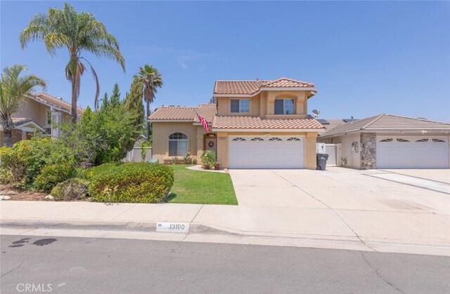13100 Red Corral Dr, Corona, CA 92883 - mediterranean / spanish-style home featuring stucco siding, a tiled roof, and driveway
