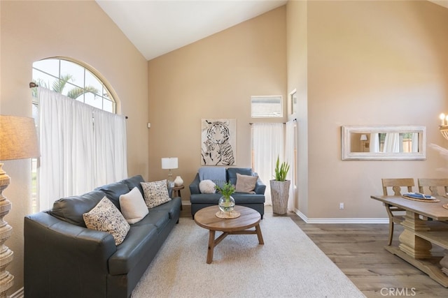 13100 Red Corral Dr, Corona, CA 92883 - living area with high vaulted ceiling, wood finished floors, and a chandelier