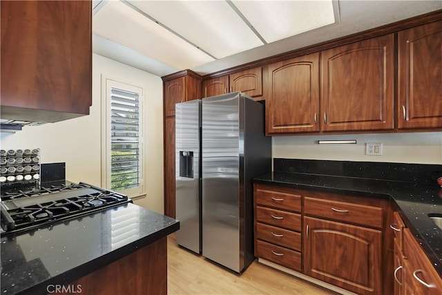 1103 Stone Pine Ln Unit C, Corona, CA 92879 - kitchen featuring stainless steel fridge with ice dispenser, light wood finished floors, and dark stone countertops