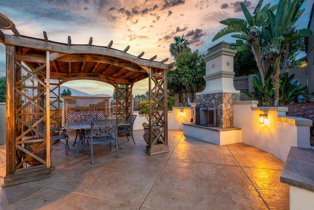 9915 Jacoby Rd, Spring Valley, CA 91977 - view of patio with an outdoor stone fireplace and outdoor dining area