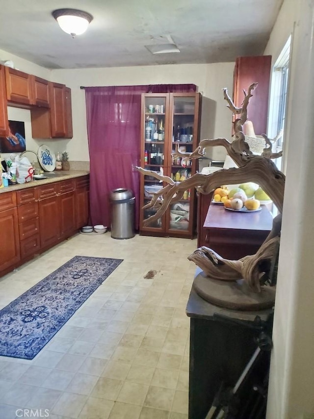 1518 E Luray St, Long Beach, CA 90807 - kitchen featuring light countertops, light flooring, and dark brown cabinets