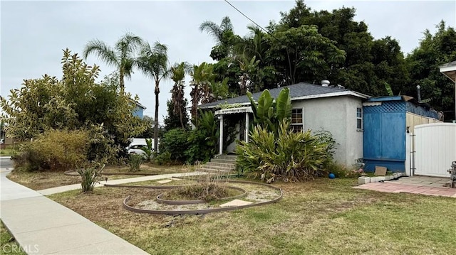 1518 E Luray St, Long Beach, CA 90807 - view of front of house with a front lawn, a gate, and stucco siding