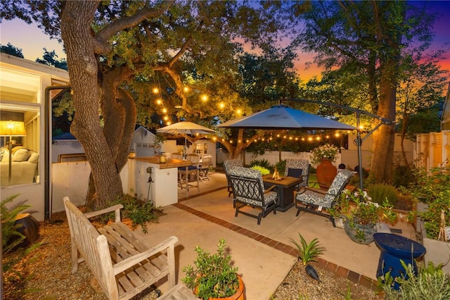 365 N Ivy Ave, Monrovia, CA 91016 - patio terrace at dusk featuring a fire pit and a patio area