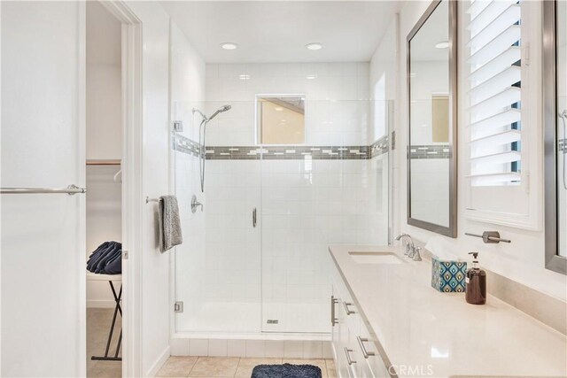97 Eclipse, Lake Forest, CA 92630 - bathroom with a stall shower, vanity, a spacious closet, tile patterned flooring, and recessed lighting